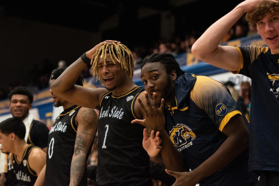 Kent State basketball players VonCameron Davis (left) and London Maiden (right) celebrate from the bench as the Golden Flashes score once again during the game on Jan. 20th, 2023.