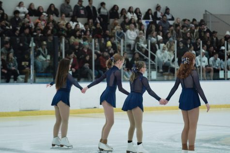 At a hockey game, the Kent State Club Figure Skating members perform after the first period on Jan. 20, 2023.