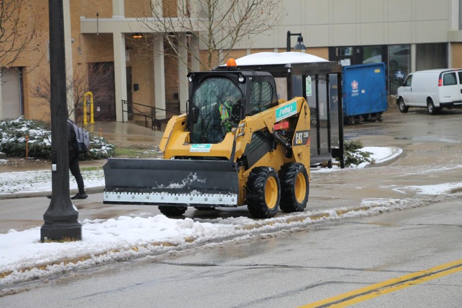 Kent State maintenance clearing the sidewalks outside of student dorms. 