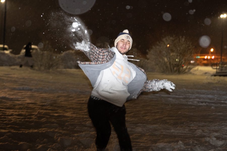 Kent State student Edward Miller VI of throws a snowball that falls apart as it flies during the annual snowball fight behind Taylor Hall on Jan. 22, 2023. 