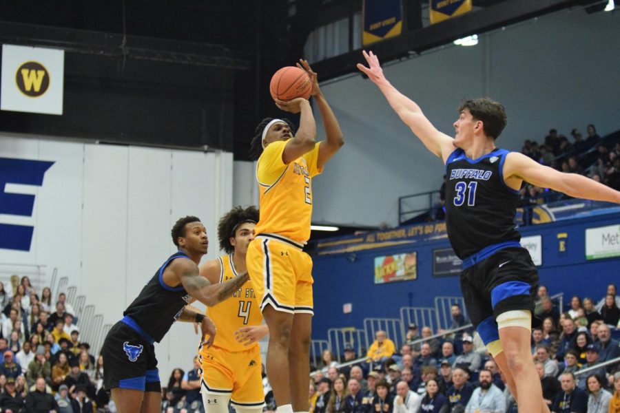 Kent State Redshirt senior Malique Jacobs shoots a three-point basket as Buffalo University freshman Isaac Jack attempts to defend him at the home game on Jan. 27, 2022.
