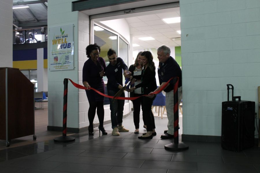 Faculty and students cutting the ribbon to announce the opening of the Well Hub located in the Student Recreation and Wellness Center Feb. 22, 2023.