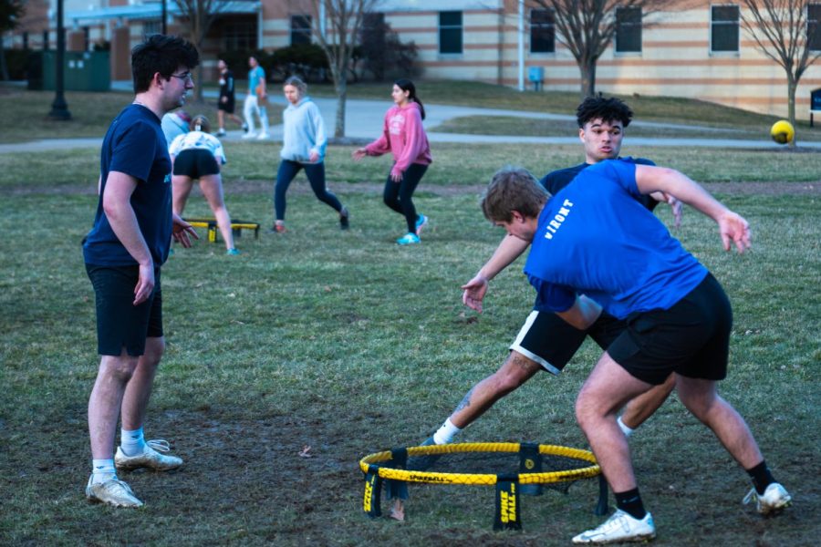Andrew Brion (left), Ty Fields (center) and Joe Viront practice spike ball on Centennial Court Green Feb. 23, 2023. All of them are members of the Kent State Round Net Club, and Fields is their president. 