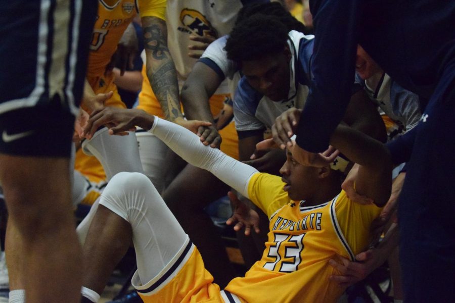 Redshirt Senior Miryne Thomas gets boosted up by his teammates after being knocked over in the game against Akron University on March 3, 2023.