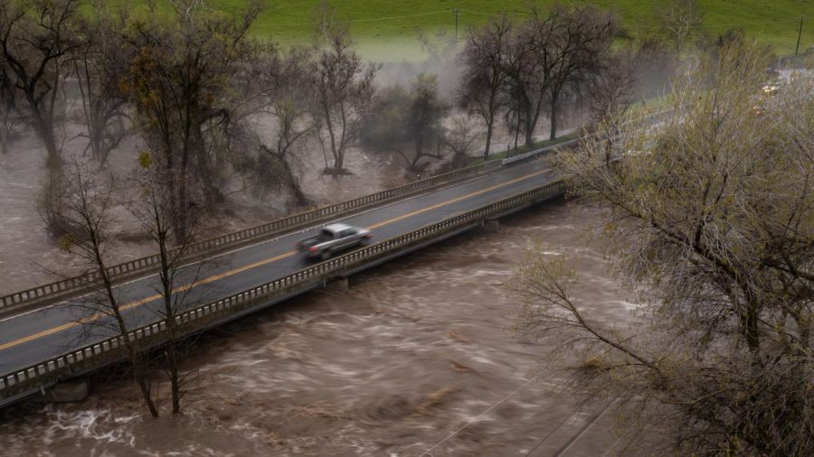 A pickup truck crosses a bridge over the flooding Tule River on March 10 near Springville, California. David McNew/Getty Images