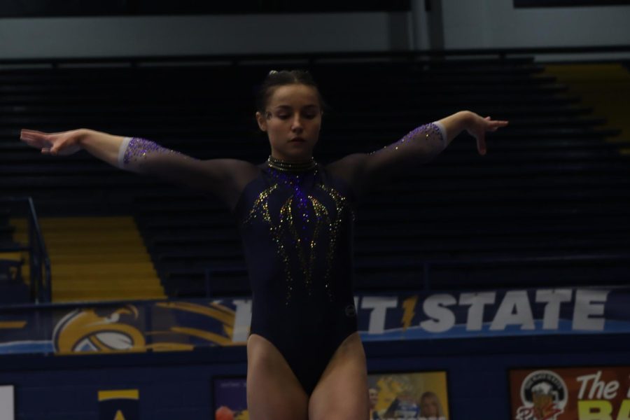 Grace Wehry, a sophmore in biotechnology, preforming her balance beam routine during the Kent vs. Michigan meet March 12.