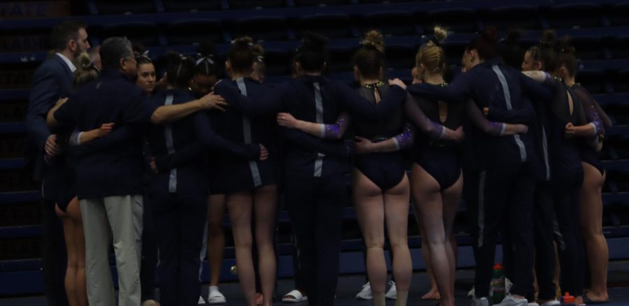 The gymnastics team doing one last huddle after losing by 0.25 during the Kent vs Michigan meet on 3/12/23