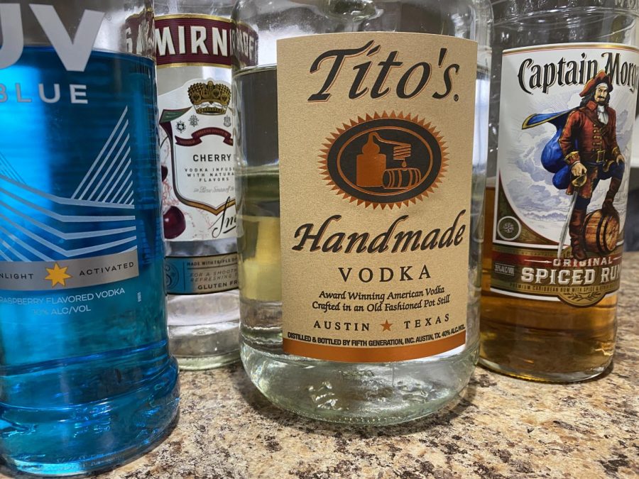 Different types of alcohol sit on a countertop. Seidel said people may turn to alcohol to lower inhibitions during social events.