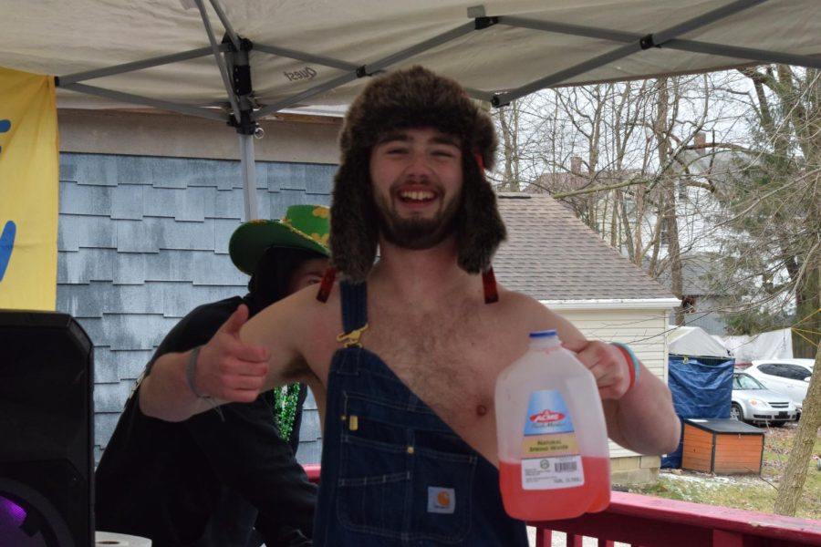 JD Lancaster parties at TKE with overalls and a BORG, trying to stay warm while he celebrates Kent States Fake Paddys Day March 11, 2023.