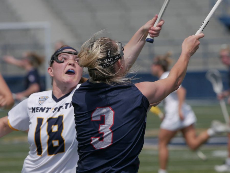 Jackie Wolford (left) tries to block a pass from Kelsey Nelson (center) at Kent States game against Robert Morris University Apr. 15.