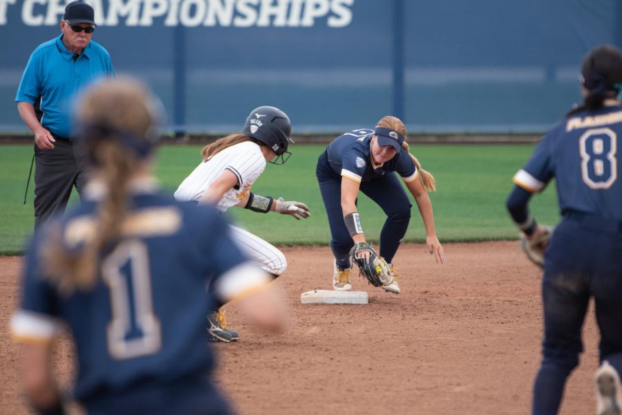 Toledo University fifth year Anna Dixon scrambles to reach a safe base as Kent State sophomore Savannah Wing and redshirt senior Alexandria Whitmore cut her off between second and third during the double header on April 15, 2023.