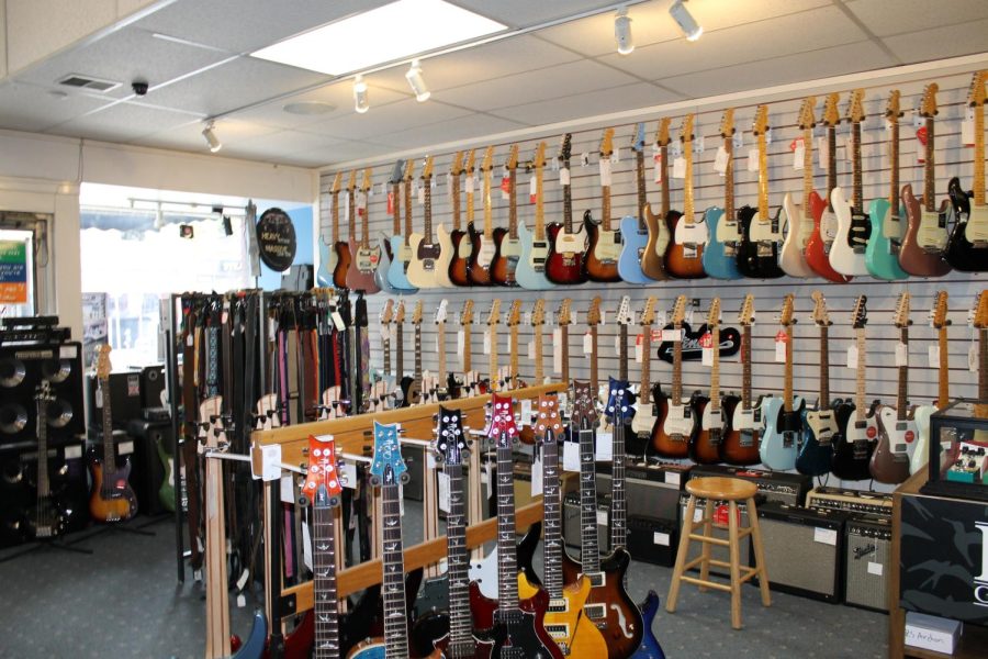 Electric guitars for sale display inside Woodsys music store.