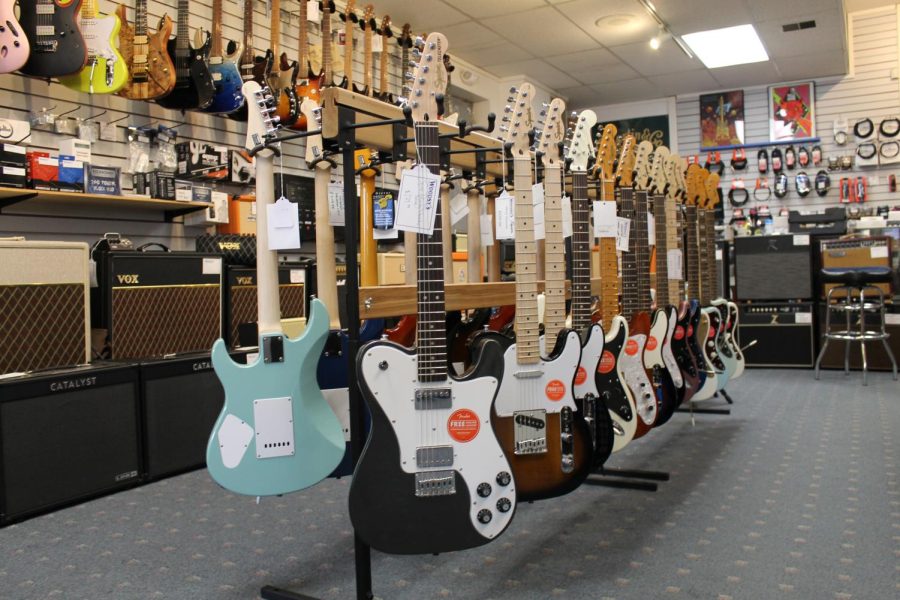 Electric guitars for sale display inside Woodsys music store.