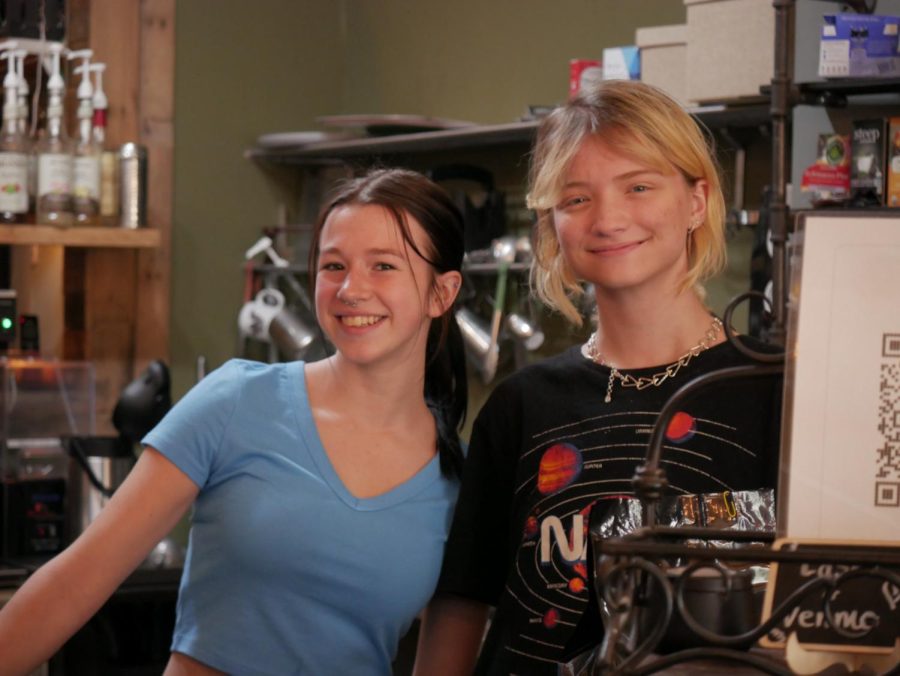 Bell Walter (left) and Emma Wells (right) candidly pose for a photograph behind the counter during their shift at Scribbles Coffee Co. in Downtown Kent. Apr. 30.