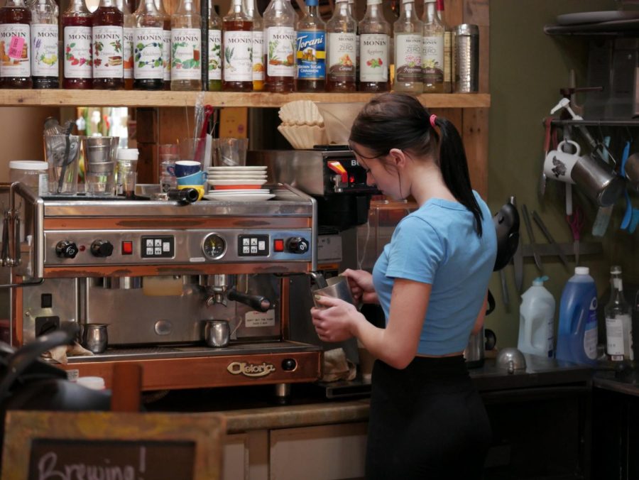 Bell Walter steaming milk for a latte during a Sunday shift at Scribbles Coffee Company in Downtown Kent Apr. 30.