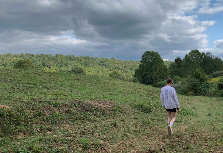 Dylan Walker steps across a field in Appalachia, Ohio. 