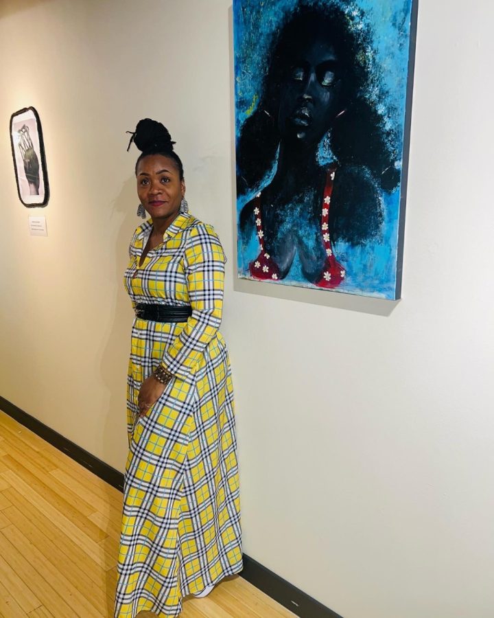 Vanessa Faith stands next to her painting portraying an adult woman embracing her inner child. 
