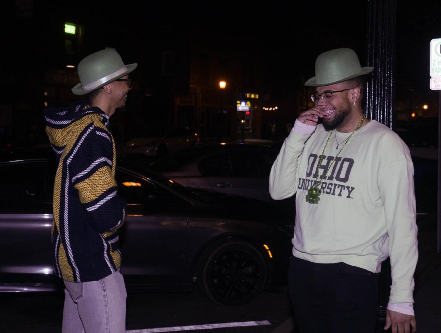 Mychal Wicker (left) and Cameron Subbs (right) wait outside bar 157 Lounge to continue the festivities of Kents Fake Paddys Day Celebration Mar. 11.