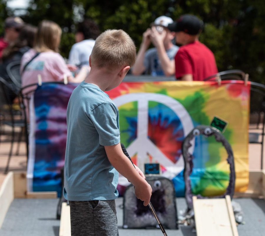 Children and parents participate in the annual Putt Around Kent on May 6, 2023. Businesses across downtown Kent like Hippie Fox Rocks set up mini-golf holes for golfers to try their hand at.