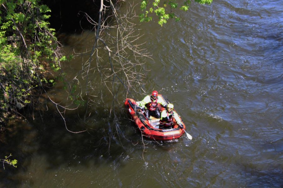 Members of the Portage County Water Team travel along the Cuyahoga River after clearing fallen trees that blocked the river passage.