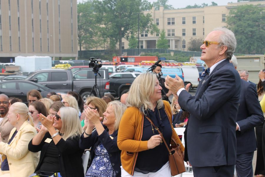 Kent State President Todd Diacon, along with trustees and administrators, applaud the placement of last beam of Crawford Hall on June 28, 2023. 