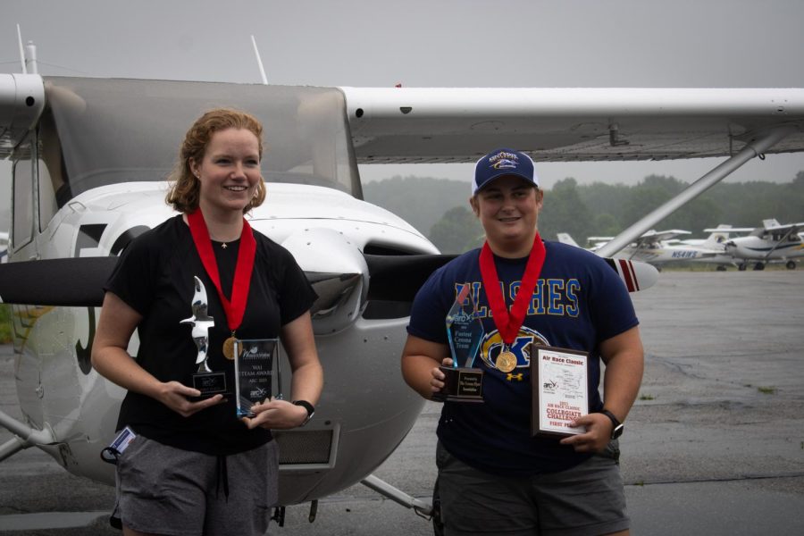 Pilots Laura Wilson (left) and Peyton Turner (right) pose with their trophies in front of their plane after returning from winning this years Air Race Classic. 