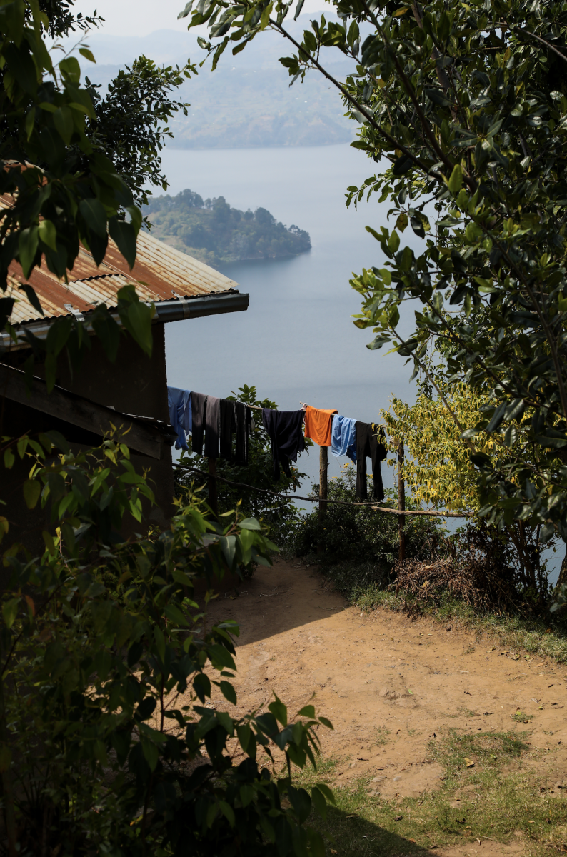 Clothes hang on a clothesline outside of Fraterne’s childhood home in Birwa, Rwanda, with Lake Burera in the background.