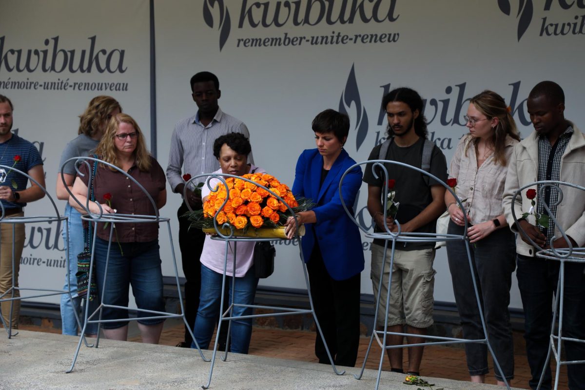 Sarah Schmidt and her students honor the people killed during the genocide in Rwanda by placing a wreath of flowers at the genocide memorial.