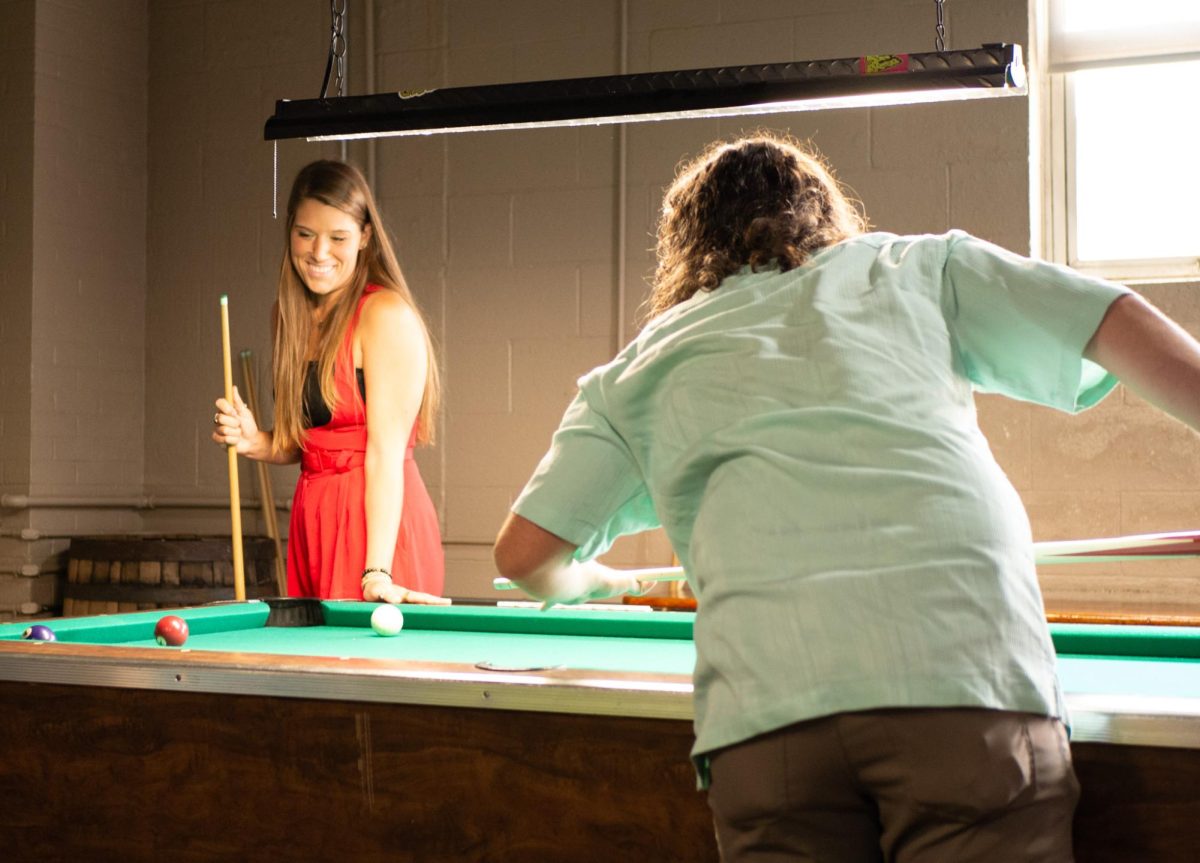 Tiffany Poth (left) and Emmet Roberts (right) enjoy a game of pool at Madcap Brew Co. in Kent during the Crafty Crawl Aug. 27, 2023.