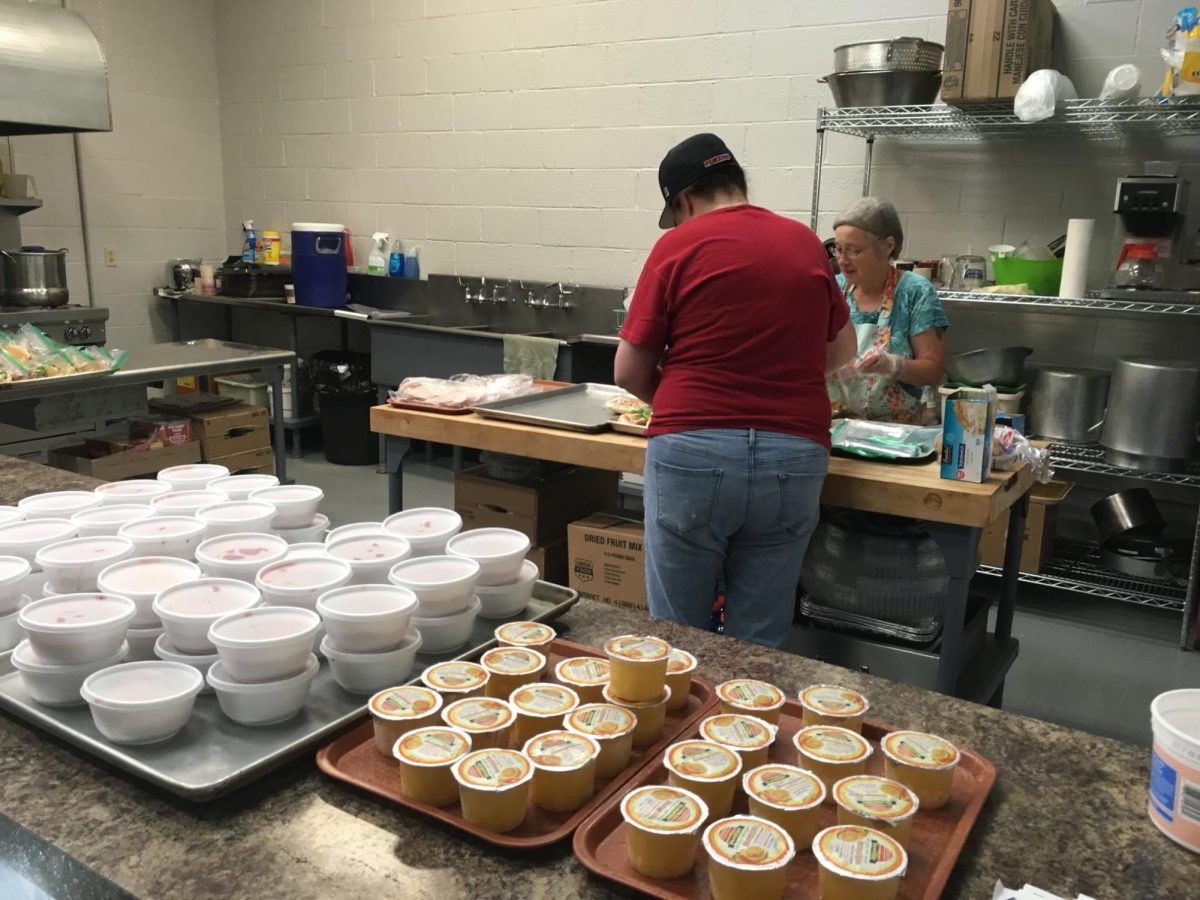 Two people help prepare food for Lovelights Summer Meal Delivery program, where the nonprofit provided meals to children ages 18 and under around the community. 