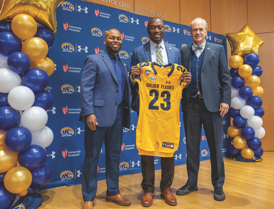 New Kent State football coach Kenni Burns (center) poses with university athletic director Randale Richmond (left) and university president Todd Diacon (right) at Burns’ first press conference Dec. 16, 2022. Courtesy of Kent State Athletics