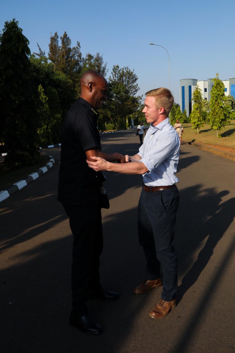 Miles Listerman, Kent State Business major, shakes hands with a member of Rwanda’s national police. Rwanda has a community based policing system that promotes trust between community members and the police.