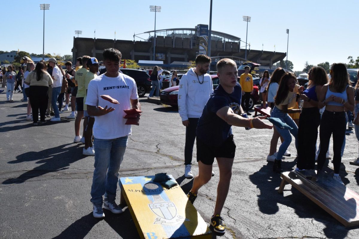 Kent State Students and members of Alpha Tau Omega play corn hole while tailgating the Kent State State vs. Central CT St. football game on Sept. 16, 2023. 