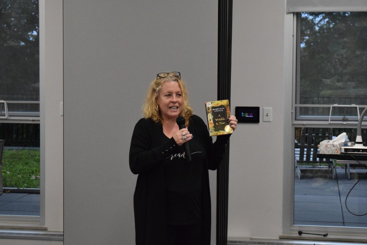 Director Meghan Harper talks to the crowd in Taylor Hall and reads excerpts from A Wrinkle in Time by: Madeleine LEngle at the Banned Book Read-In on Sept. 27, 2023.