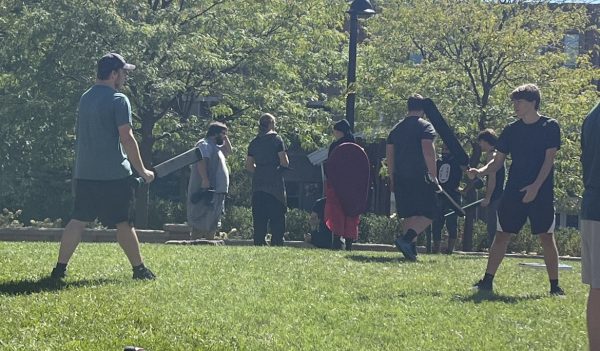 Live Action RolePlay Club (LARP) practices on Risman Plaza on September 15, 2023, dressed in decorative costumes and using fake swords in their battle. 