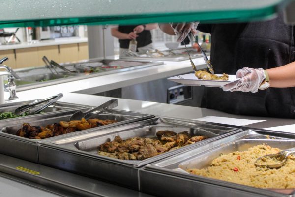 An employee at the Design Innovation Hub dining hall serves food to Kent State students on Sept. 6, 2023.