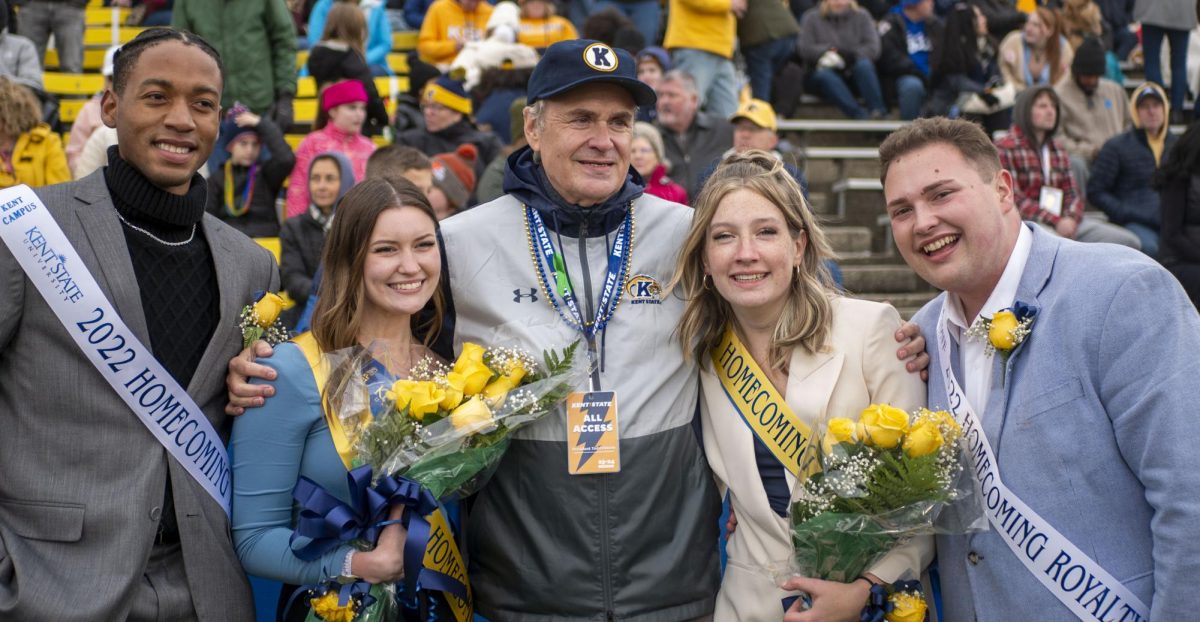 Kent State President Dr. Todd Diacon (center) stands with the 2023 Homecoming Royalty Julie Buonaiuto (center left) and Sage Mason (center right) and 2022 Homecoming Royalty Quintin Cooks (far left) and Gavin Aitken (far right) at halftime of the Kent State vs. Buffalo football game on Oct. 21, 2023.