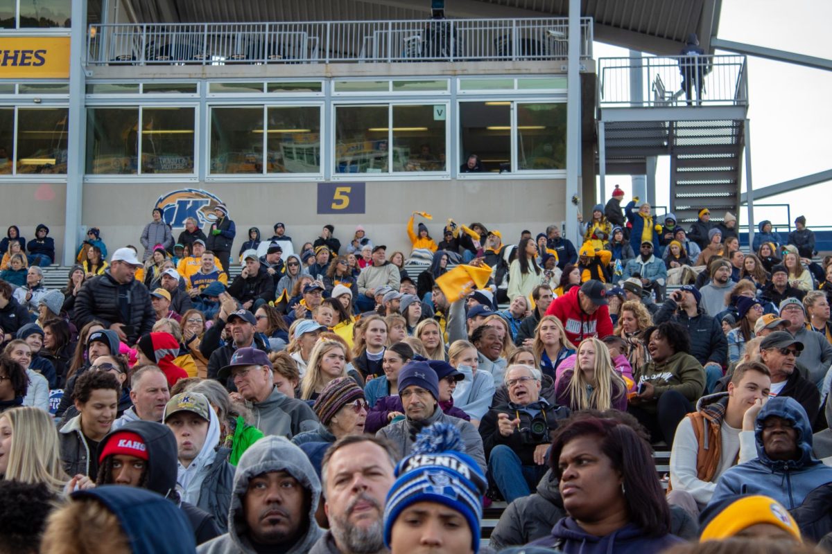 Fans cheer and wave Kent State apparel in support of the team during the Homecoming game on Oct. 21, 2203.