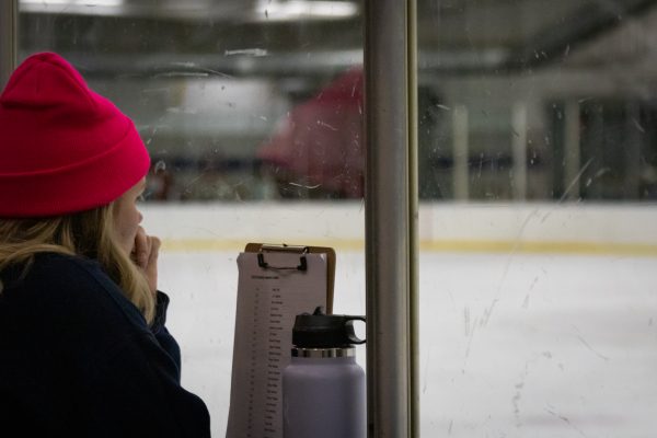 Carolina Heister, the media marketing manager for the Kent State d1 hockey team, watches the Kent Vs. Syracuse game on Oct. 13, 2023.