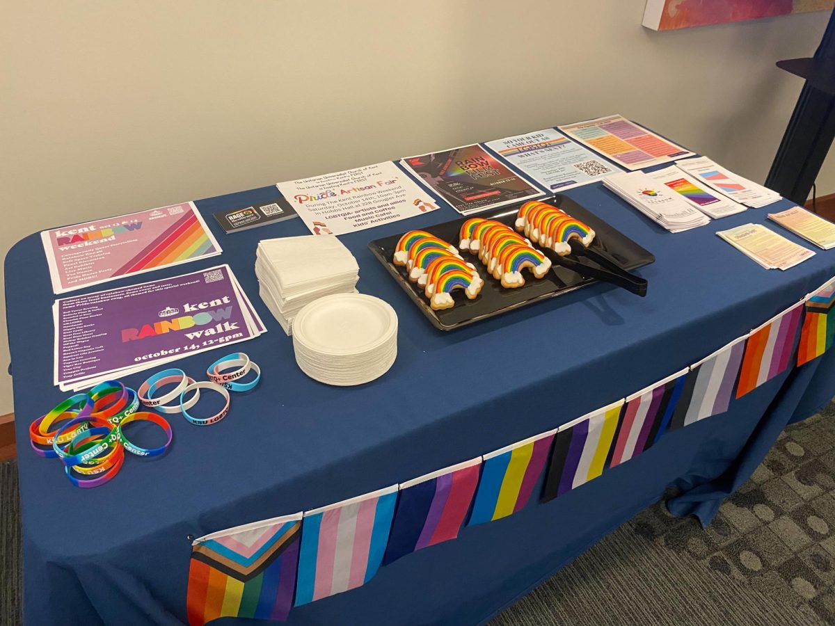 A table with colorful cookies and resource fliers were set up for National Coming Out Day on Oct. 11, 2023.