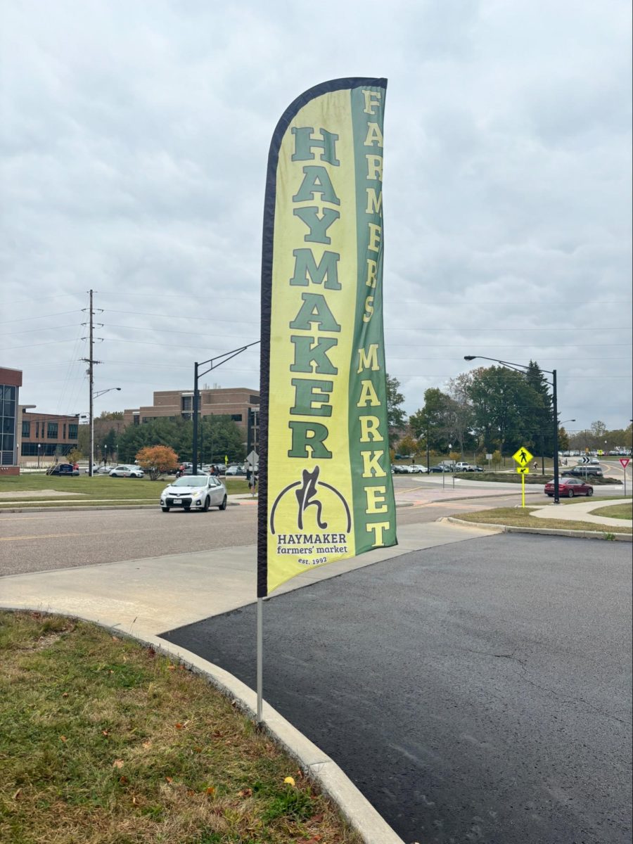 The Haymaker Farmers Market sign sits near the  entrance of the Campus Rec Lot. 