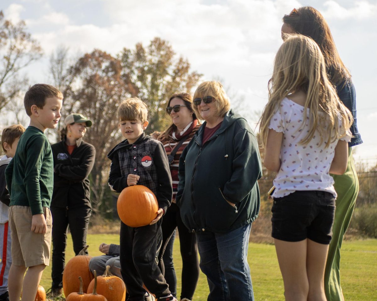 Event-goers+of+all+ages+gather+at+the+Brimfield+Pumpkin+Roll+with+fruit+in+hand+to+compete+in+pumpkin+rolling+contests+on+Nov.+5%2C+2023.