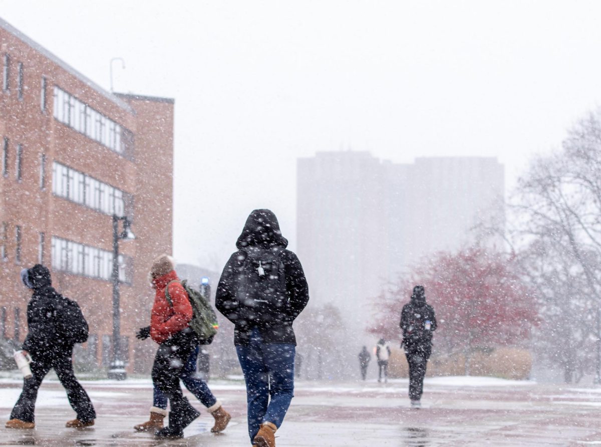 Kent State students walk through heavy snowfall as they make their way along the esplanade on Nov. 28, 2023.
