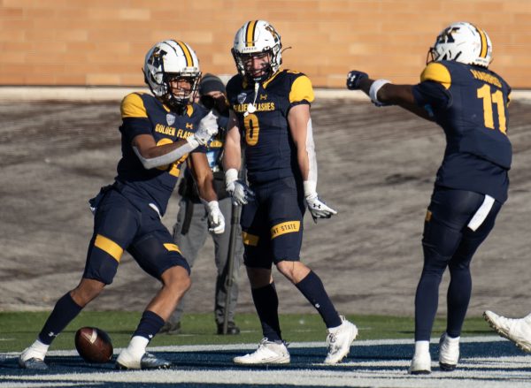 Kent State sophomore wide receiver Trell Harris and senior wide receiver Luke Floriea celebrate with sophomore wide receiver Jameel Gardner Jr. after Gardners touchdown during the Northern Illinois game on Nov. 25, 2023.