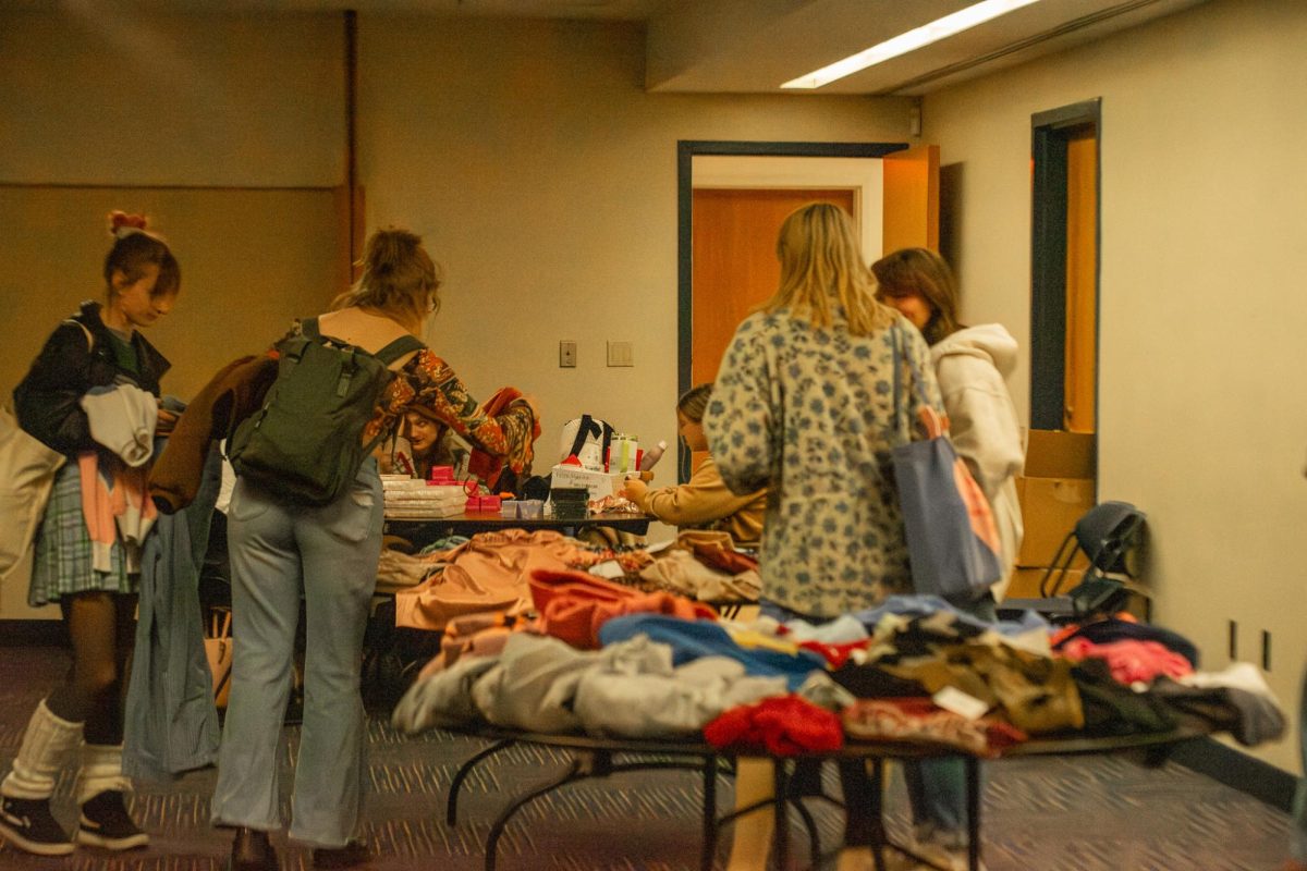 Students trying to figure out what they want at the Her Campus thrift store event on Nov. 30, 2023. 