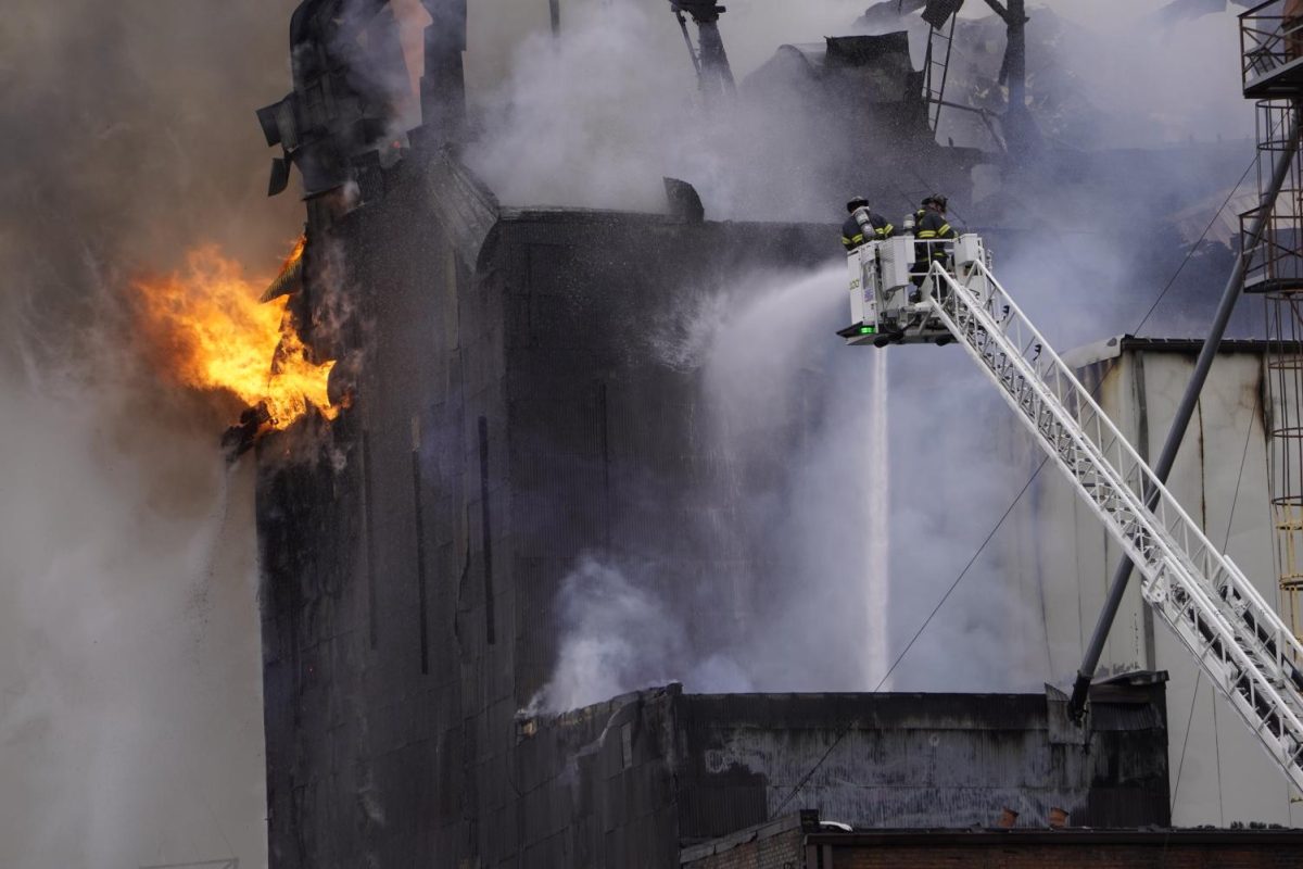 Firefighters spray down the massive fire at the Star of the West mill complex in downtown Kent on Dec. 2, 2022. More than seven local fire companies responded to the blaze, which began just before 9 a.m. 