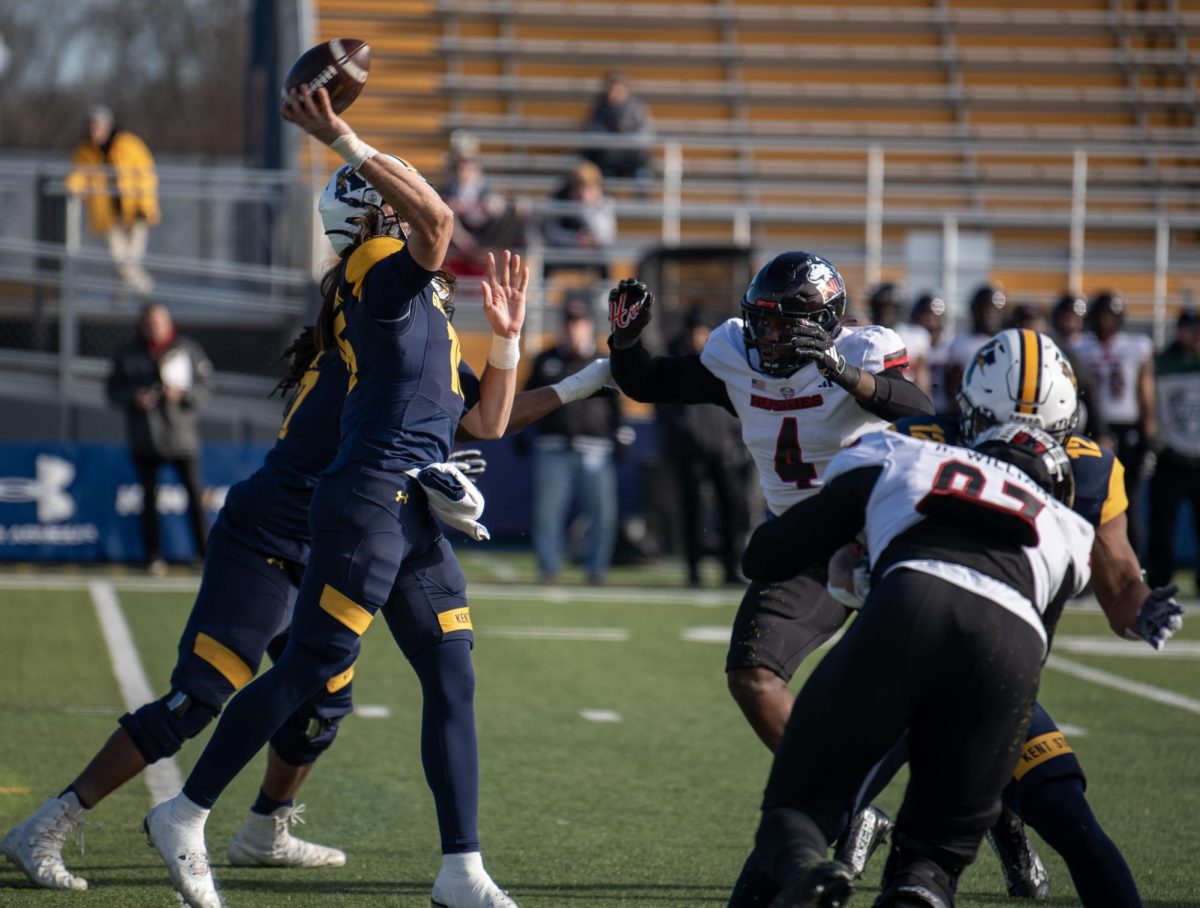 Kent State sophomore quarterback Devin Kargman attempts a pass under pressure from Northern Illinois defensive end Ray Thomas during the Nov. 25, 2023 game.