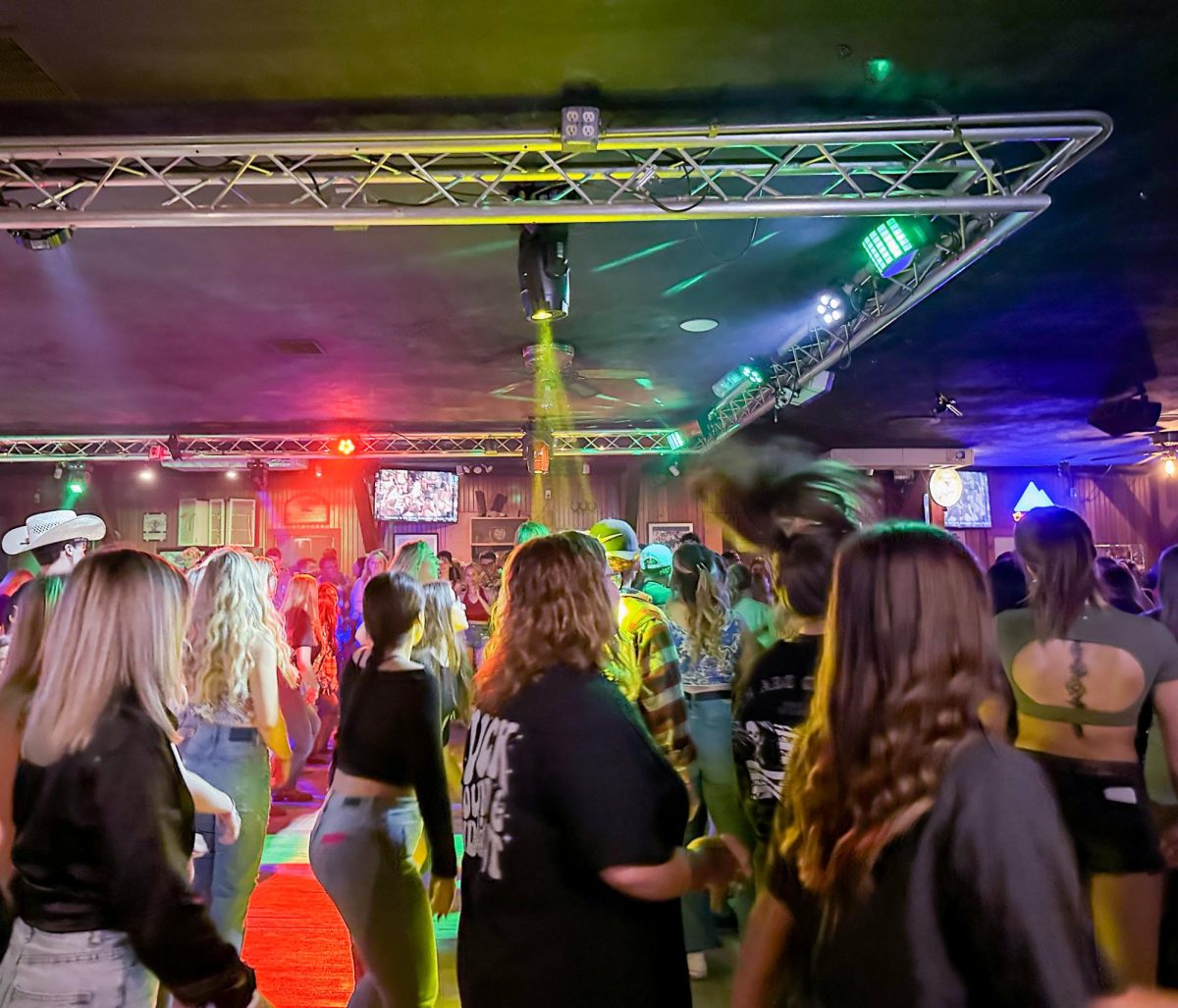 A group of people hit the dance floor at the Dusty Armadillo to line dance and have some fun. 
