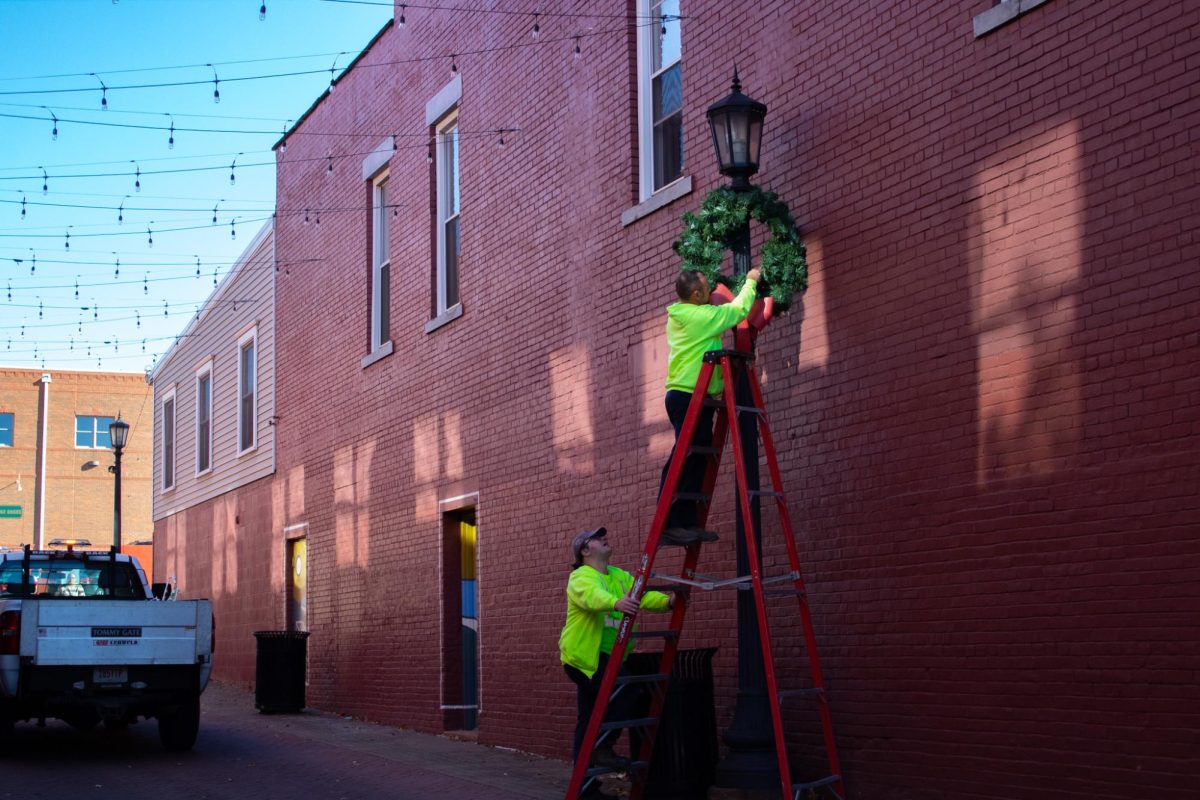Workers hang wreaths in Downtown Kent as the holiday season nears.