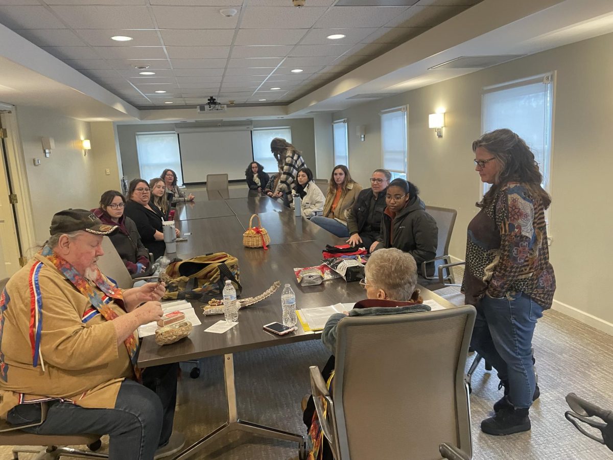 Nell and Jim Orndof leading a group craft exercise of making Native American prayer ties at the Williamson Alumni Center.